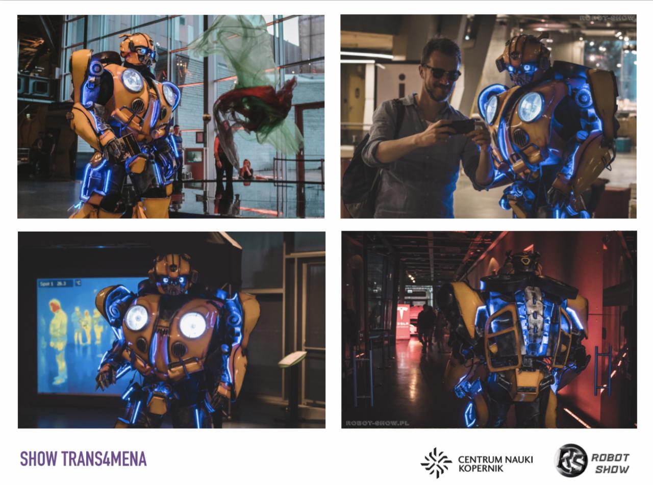 Żółto-czarny kostium robota z niebieskim oświetleniem LED prezentowany na tle nowoczesnej architektury i interaktywnych ekspozycji wewnątrz budynku.