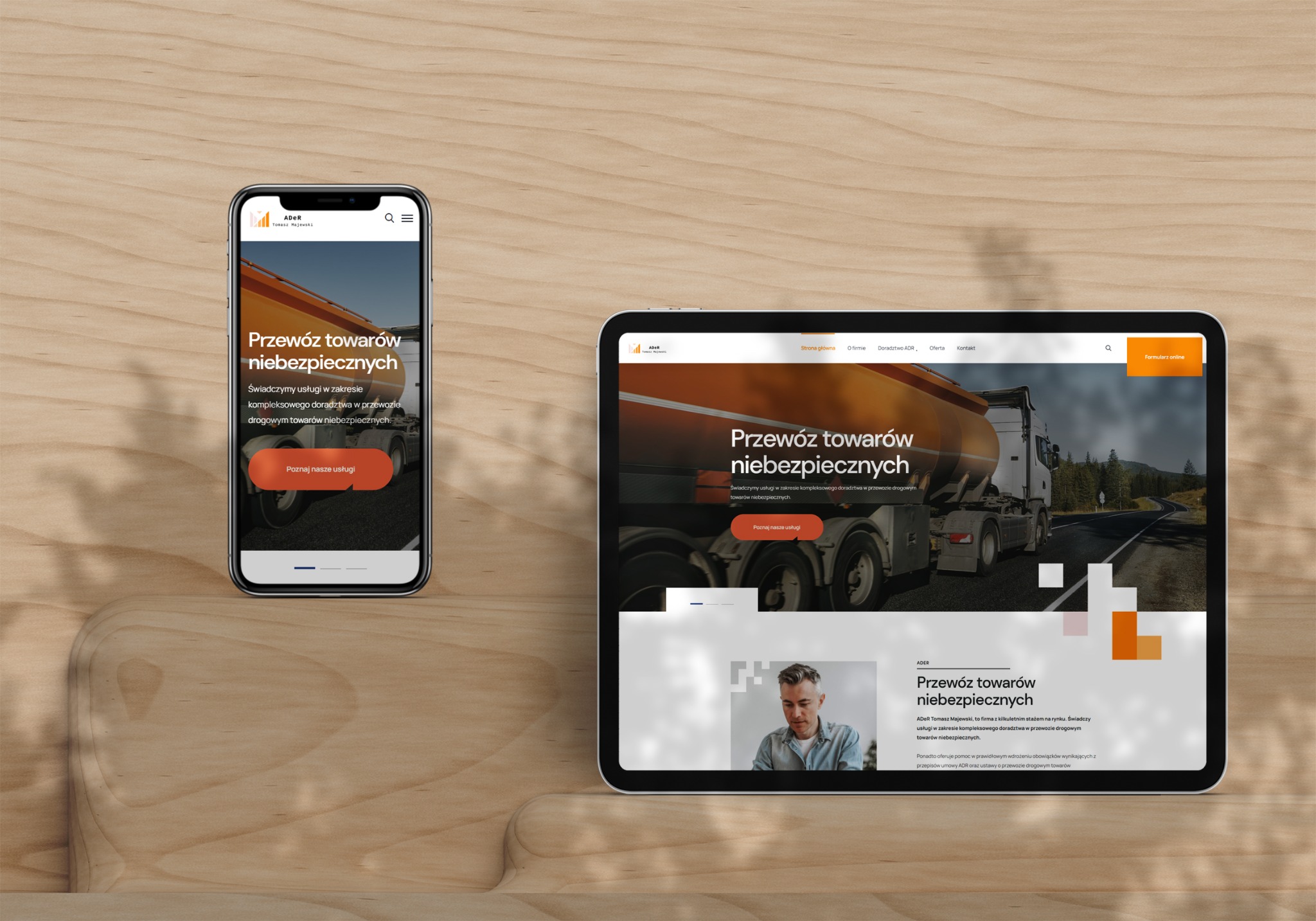 Prezentacja responsywnej strony internetowej na tablecie i smartfonie, wyświetlająca ofertę firmy transportowej specjalizującej się w przewozie towarów niebezpiecznych, z widocznym logo i hasłem.