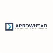 Logo firmy Arrowhead Properties & Investments z niebieskim symbolem strzałki w kwadracie po lewej stronie nazwy.