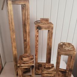 DariaSworowska - Ręcznie robione drewniane lampiony w różnych rozmiarach, z efektem przypalenia i sznurkowymi uchwytami, ustawione na białym tle.