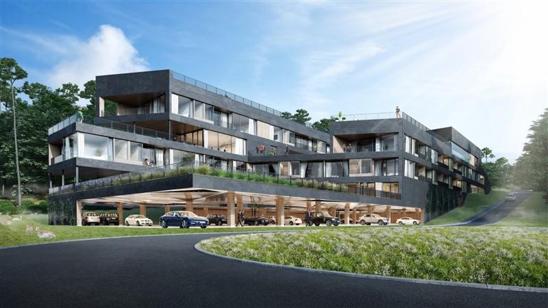 Wizualizacja nowoczesnego, wielopiętrowego budynku usługowego z podziemnym parkingiem, otoczonego zielenią i lasem; widoczne osoby na balkonach i dachu.