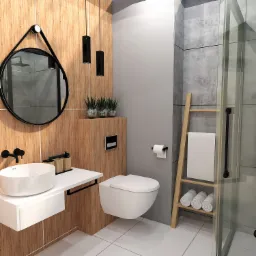 Nowoczesna łazienka z drewnianymi panelami, okrągłym lustrem na pasku, wiszącą toaletą, białą umywalką nablatową i drewnianą drabinką na ręczniki.