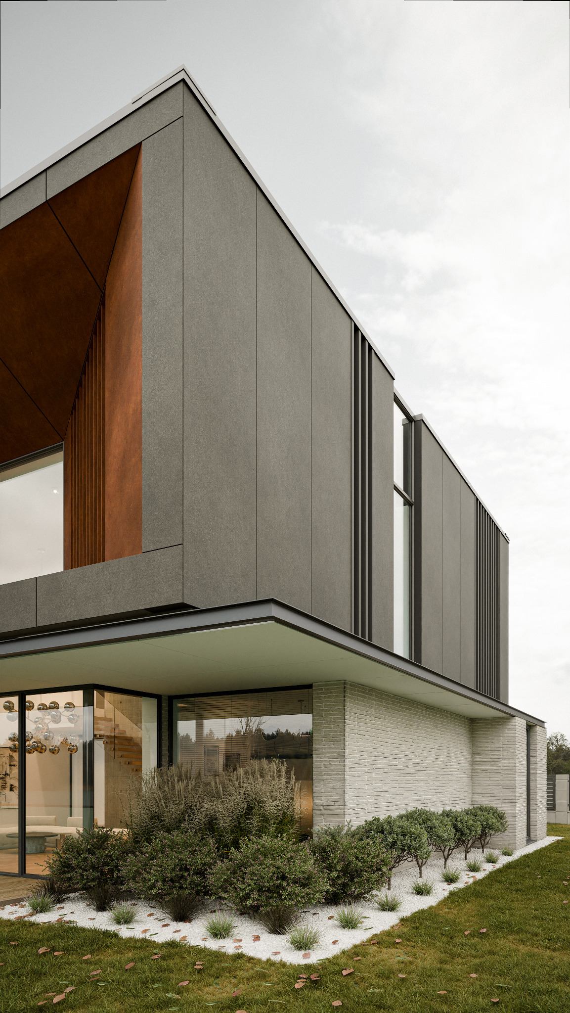 Nowoczesny dom z elewacją w odcieniach szarości i brązu, duże okna, minimalistyczny ogród z białym żwirem i zielenią. Architektura z wyraźnymi liniami i geometrycznymi kształtami.