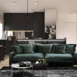 Eleganckie wnętrze mieszkania w odcieniach szarości i zieleni z akcentami czerni, prezentujące otwartą przestrzeń salonu z kuchnią, z zieloną sofą na pierwszym planie i minimalistyczną zabudową...