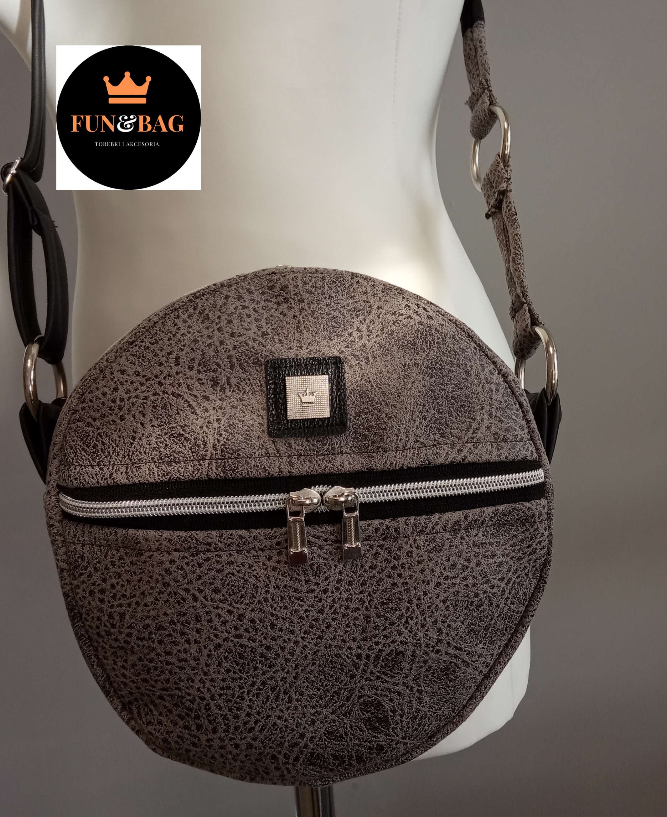 Okrągła torebka z szarej skóry ekologicznej z zamkiem błyskawicznym, prezentowana na manekinie z widocznym logo producenta Fun&Bag.