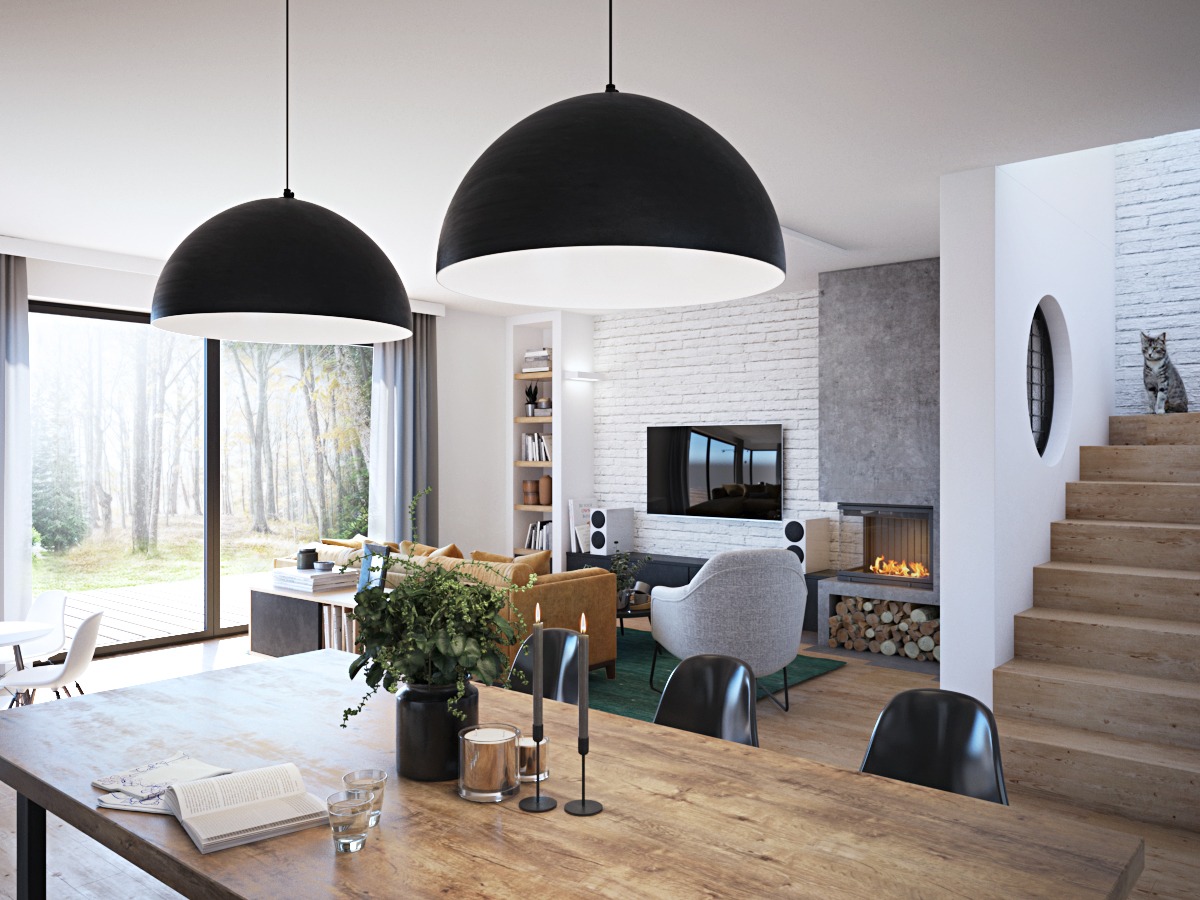 Jasne wnętrze domu z drewnianym stołem, czarnymi lampami kopułowymi, kominkiem, białymi cegłami na ścianie i kotem siedzącym na schodach.