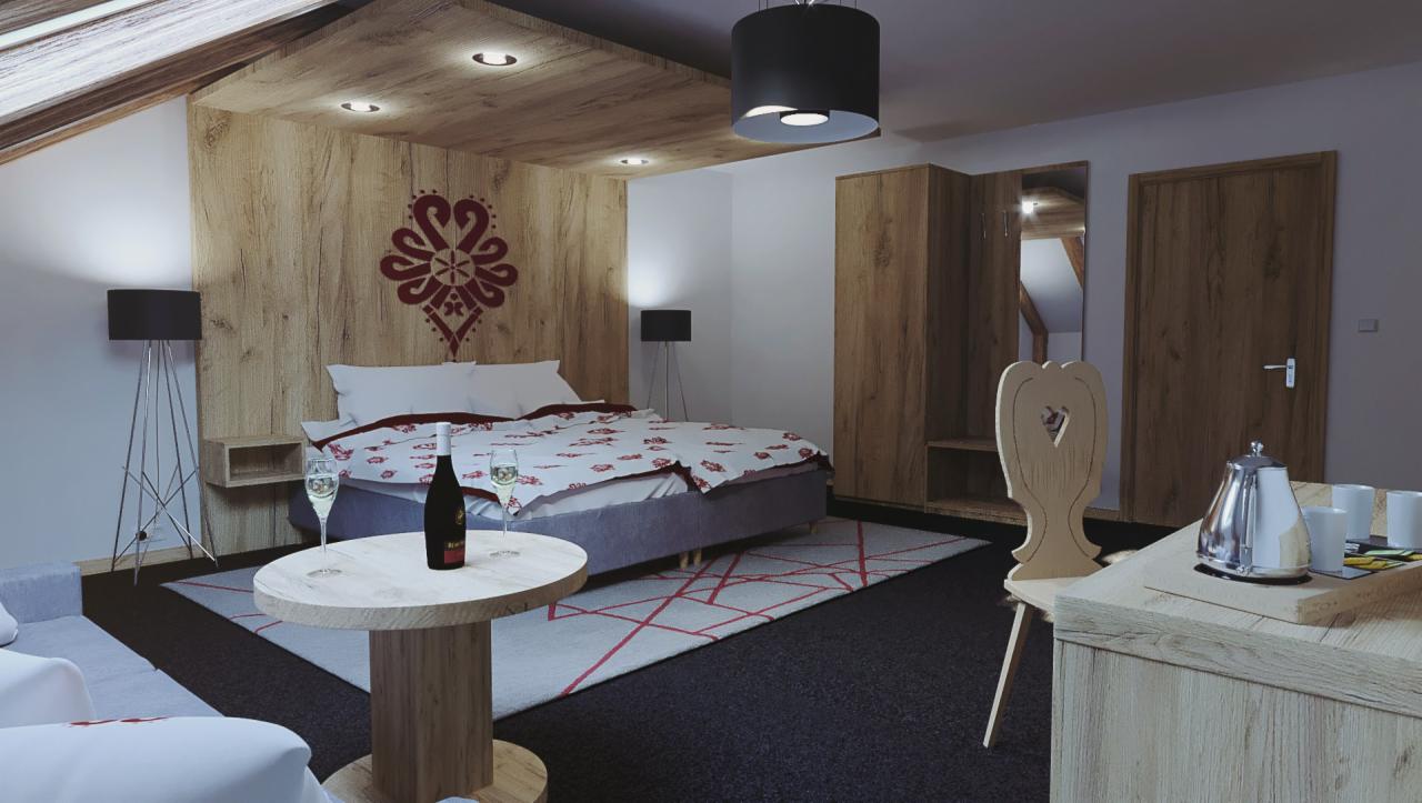 Pokój w stylu góralskim z drewnianą boazerią, wzorem na ścianie za łóżkiem, drewnianymi meblami i lampą na trójnogu, nakryty stół z napojami.