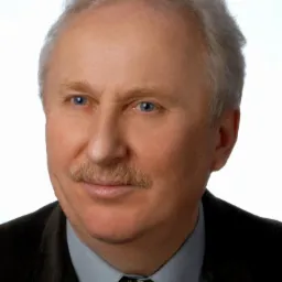 Portret mężczyzny z wąsami, w garniturze i krawacie, na białym tle.