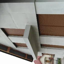 Szara elewacja domu z brązowymi panelami dekoracyjnymi, widok z dołu, ukazujący geometryczny układ elementów.