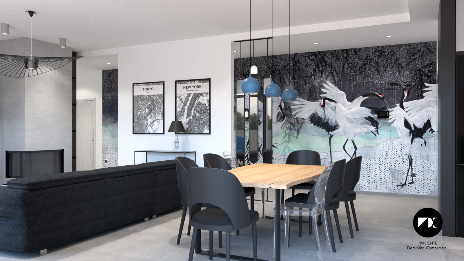 Jasne wnętrze domu z otwartą przestrzenią: salon z ciemnoszarą sofą, jadalnia z drewnianym stołem i czarnymi krzesłami, na ścianie grafika z motywem żurawi, plakaty z mapami Tokio i Nowego Jorku.