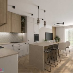 Studio Metr Na 2 - Projektowanie Wnętrz i Mebli - Jasna kuchnia z wyspą i drewnianymi akcentami. Uwagę przykuwają lampy wiszące w kształcie kamieni i parkiet ułożony w jodełkę. Widoczne sprzęty AGD i dekoracje.