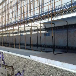 Zbrojenie stropu żelbetowego z widoczną siatką stalową, prętami zbrojeniowymi i elementami dystansowymi z tworzywa sztucznego, przygotowane do zalania betonem.