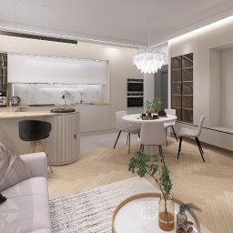 Katarzyna Zając Pracownia Architektoniczna - Jasne wnętrze: salon z aneksem kuchennym i jadalnią. Parkiet w jodełkę, pastelowe meble, minimalistyczne oświetlenie. Widoczny fragment sofy i stolika kawowego.