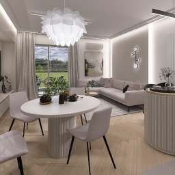Katarzyna Zając Pracownia Architektoniczna - Jasne, nowoczesne wnętrze salonu z jadalnią: okrągły stół z krzesłami, sofa narożna, telewizor i dekoracje. Duże okna z widokiem na zieleń. Subtelne oświetlenie.