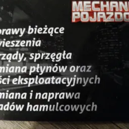 Wizytówka warsztatu samochodowego z napisem 'Mechanika Pojazdowa' i listą usług: naprawy bieżące, zawieszenia, rozrządy, sprzęgła, wymiana płynów i części eksploatacyjnych, wymiana i naprawa...