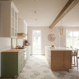 Jasna kuchnia z zielonymi szafkami, drewnianym blatem i wyspą, heksagonalna podłoga w odcieniach beżu i szarości, dekoracyjny zegar na ścianie, wiszące lampy w stylu industrialnym.