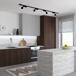 Nowoczesna kuchnia z ciemnobrązowymi szafkami, blatem z szarego kamienia, wyspą z kamienia, drewnianymi stołkami barowymi i pomarańczowym zegarem na ścianie.