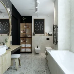 Nowoczesna łazienka z owalnym lustrem w drewnianej ramie, białą umywalką nablatową, szafką z drewnianymi frontami, szarą tapetą, czarnymi akcentami i podłogą z terazzo.