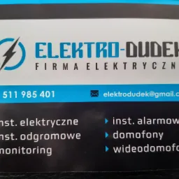 Wizytówka firmy Elektro-Dudek z logo błyskawicy w okręgu, numerem telefonu 511 985 401, adresem email elektrodudek@gmail.com oraz listą usług: instalacje elektryczne, instalacje odgromowe...