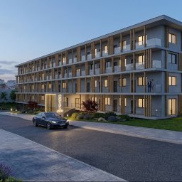 MVA Architektura Michał Bigaj - Wizualizacja architektoniczna nowoczesnego hotelu 'HOTEL ONE' z szarymi elewacjami, drewnianymi detalami, szklanymi balustradami i oświetleniem zewnętrznym o zmierzchu.