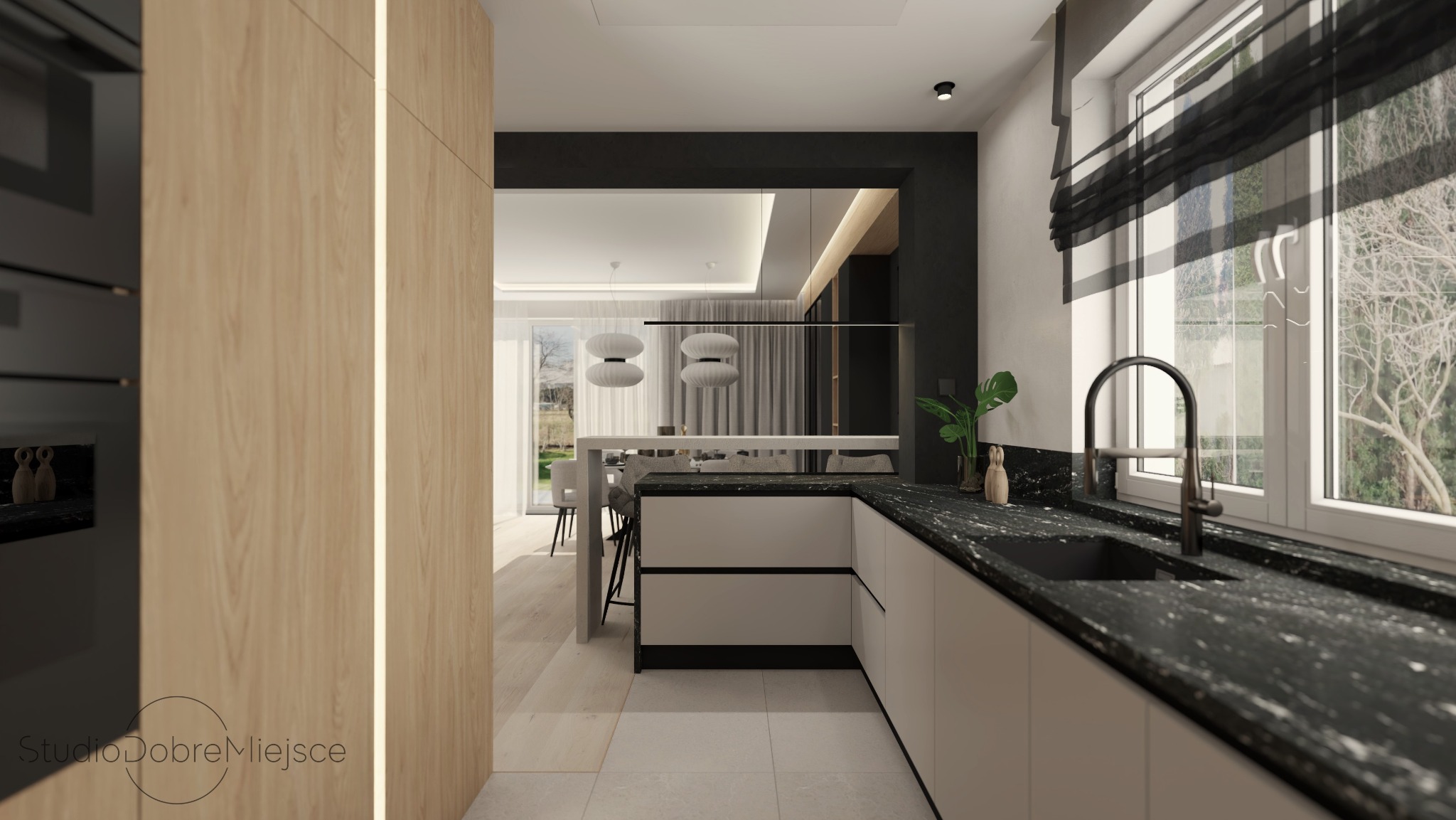 Nowoczesna kuchnia z blatem z czarnego kamienia i jasnymi szafkami. Widok na salon przez otwartą przestrzeń, z lampami wiszącymi. Minimalistyczny wystrój.
