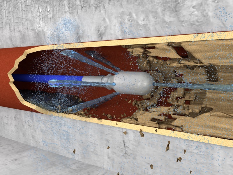 Wizualizacja czyszczenia rury od wewnątrz za pomocą strumienia wody pod ciśnieniem, widoczne odspojone zanieczyszczenia i przekrój rury.