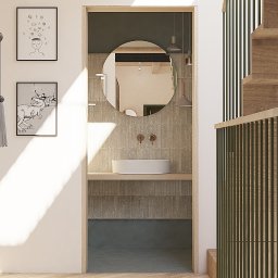 Moduu Magdalena Rosowska - Nowoczesna łazienka z okrągłym lustrem, umywalką nablatową i minimalistycznymi lampami wiszącymi. Uwagę przykuwają grafiki na ścianie i drewniane elementy schodów.