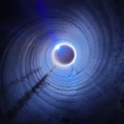 Wnętrze rury o dużym przekroju, oświetlone od końca, z widocznymi śladami po spawaniu na wewnętrznej powierzchni.