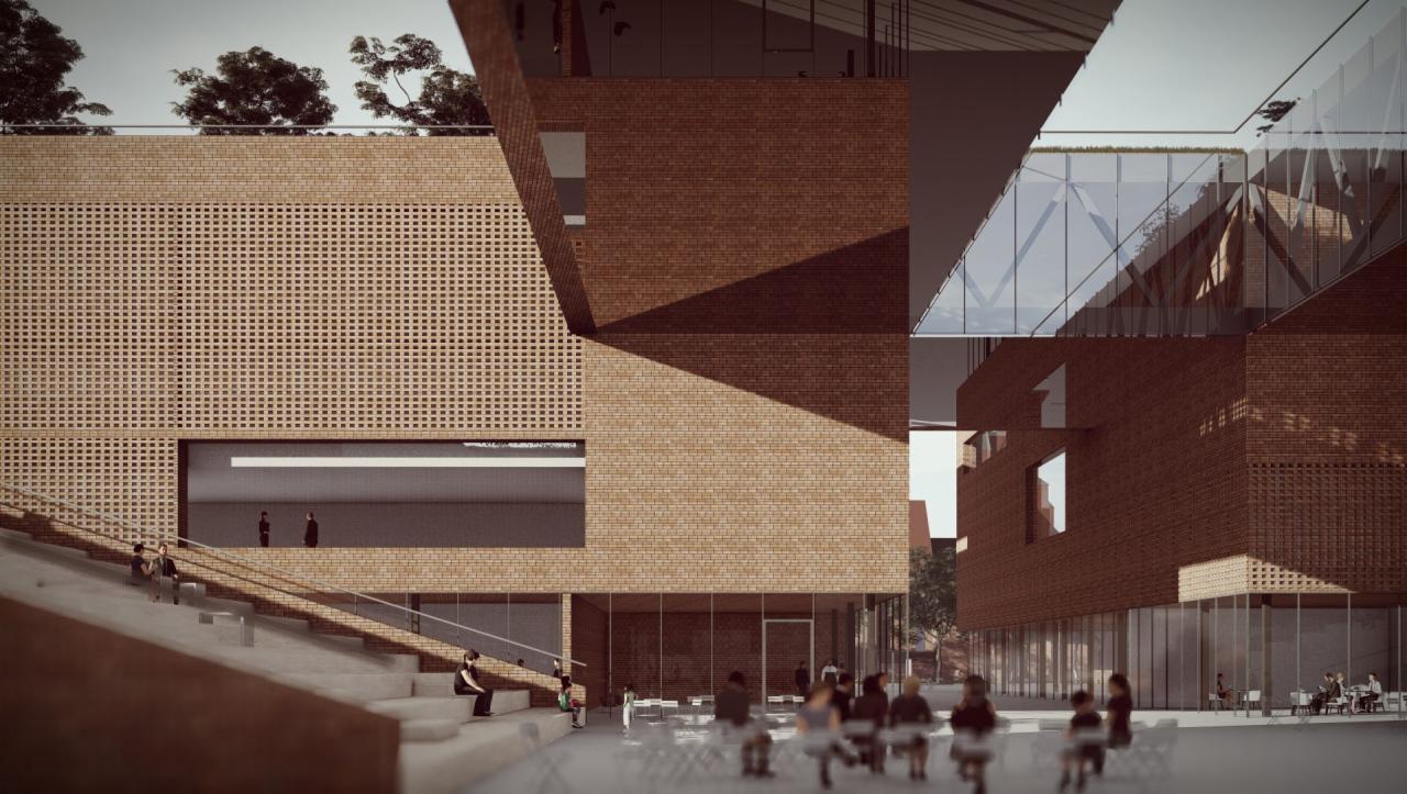 Wizualizacja budynku Ekoszkoły w Raciborzu z cegły klinkierowej, z charakterystyczną ażurową elewacją i przeszklonymi elementami, otoczona schodami i placem z siedzeniami.