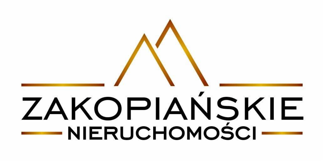 Logo firmy 'Zakopiańskie Nieruchomości' z motywem górskim w kolorze złotym na białym tle.