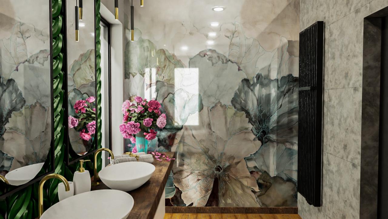 Nowoczesna łazienka z dwoma umywalkami nablatowymi, złotą armaturą, lustrem z dekoracyjną ramą z motywem roślinnym, tapetą w kwiaty i grzejnikiem drabinkowym.