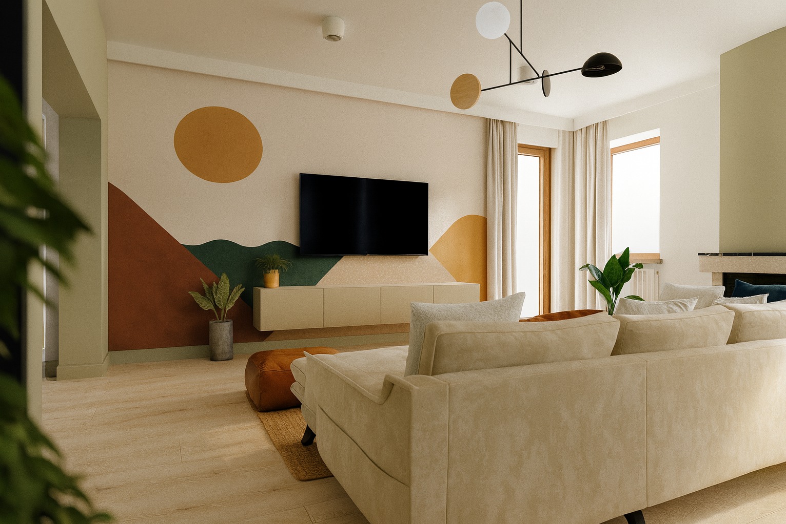 Salon z beżową sofą, ścianą w geometryczne wzory (słońce, góry), TV i szafką RTV. Całość w ciepłych, stonowanych barwach z akcentami roślinnymi.