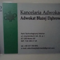 Szyld informacyjny z nazwą Kancelaria Adwokacka Adwokat Błażej Dąbrowski, umieszczony na białej ścianie, z numerem lokalu i danymi kontaktowymi.