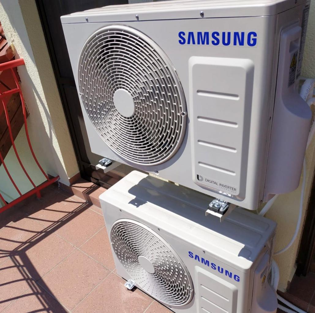 Dwie jednostki zewnętrzne klimatyzacji Samsung, zamontowane jedna nad drugą na balkonie we Wrocławiu, z widocznymi elementami montażowymi i cieniem rzucanym przez górną jednostkę.