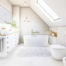 Jasna łazienka na poddaszu z wanną, umywalką nablatową i złotymi akcentami, oświetlona światłem z okna dachowego.