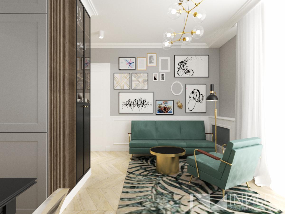Salon w odcieniach szarości z zielonymi akcentami: sofa, fotel i dywan w zebrę, ściana z galerią obrazków, złoty stolik kawowy i lampa sufitowa.