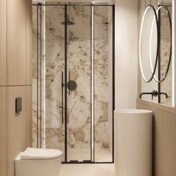 TULLAHOME Sp. z o.o. - Elegancka łazienka z kabiną prysznicową w marmurze, wiszącą toaletą i umywalką wolnostojącą. Dwa okrągłe lustra z podświetleniem.