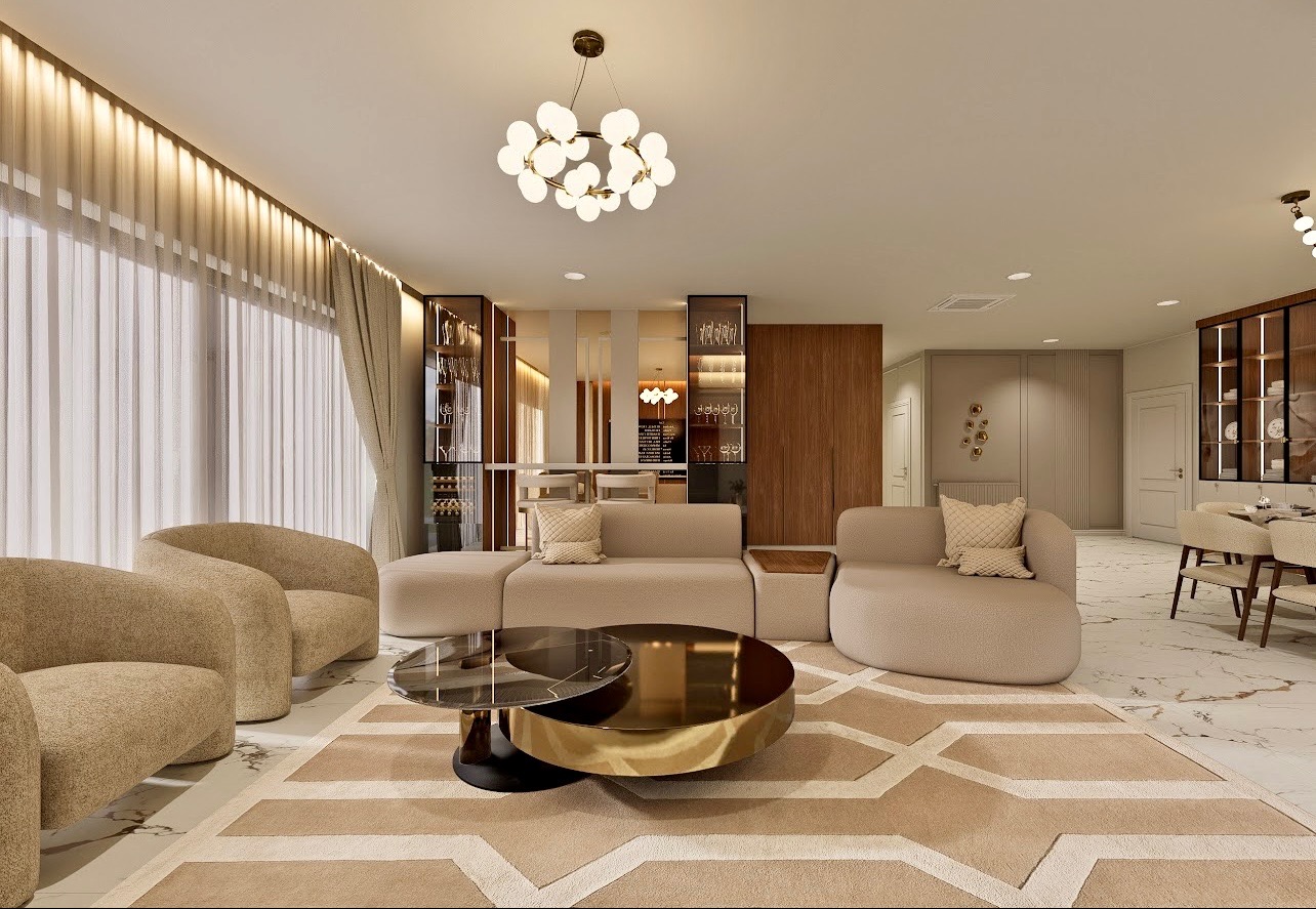 Elegancki salon z beżowymi sofami, okrągłym stolikiem kawowym z elementami złota i marmurową podłogą. W tle przeszklone witryny i jadalnia.