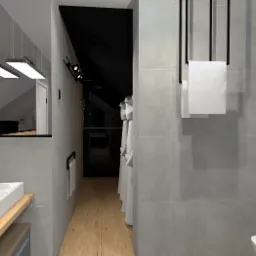 Nowoczesna łazienka na poddaszu z szarą płytką, drewnianym blatem pod umywalką i czarnymi akcentami, takimi jak armatura i wieszaki na ręczniki.