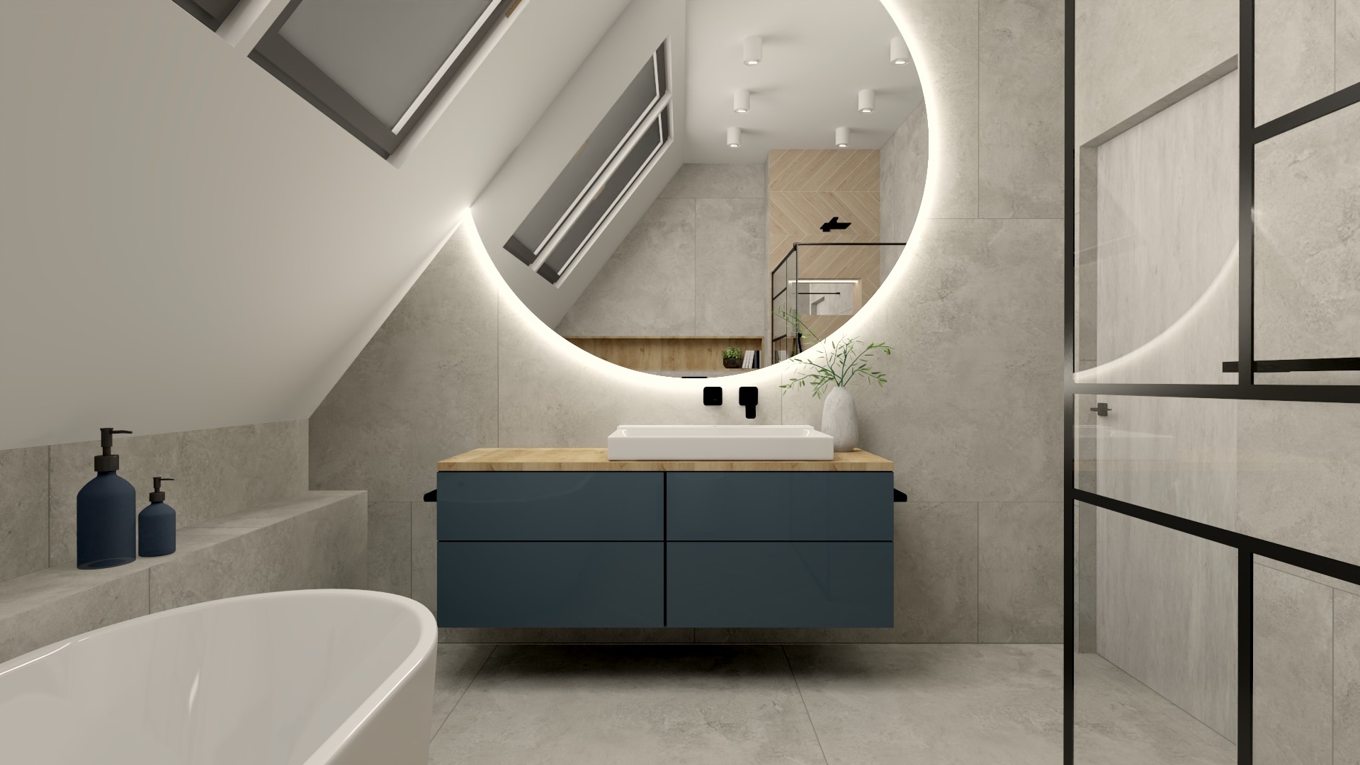 Nowoczesna łazienka na poddaszu z owalnym lustrem podświetlanym LED, umywalką nablatową na drewnianym blacie i granatowymi szafkami, widoczne okno dachowe i szklana kabina prysznicowa z czarnymi...