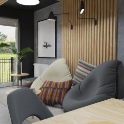 Aga Gromak - Studio Projektowe - Nowoczesny salon z szarymi ścianami, drewnianymi panelami, dużymi oknami z widokiem na ogród, designerskimi lampami ściennymi, oraz wygodnymi pufami w odcieniach szarości i beżu, uzupełnionymi...