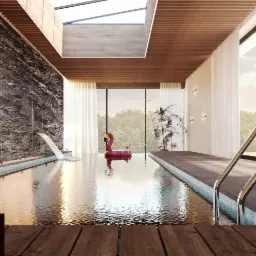 Luksusowy kryty basen z wodospadem na tle ściany z kamienia, dmuchany flaming i drewniany taras na pierwszym planie.