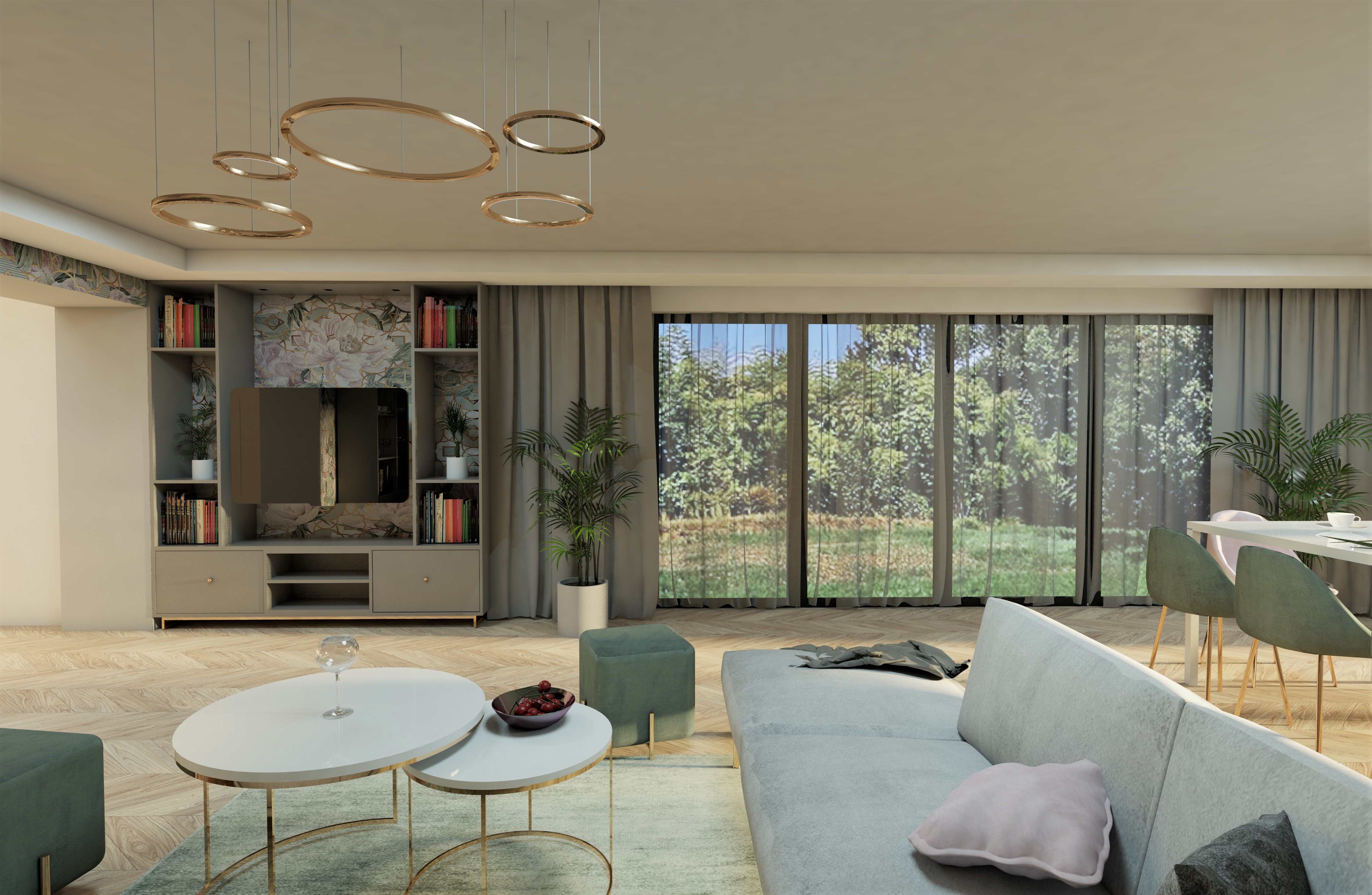 Wnętrze salonu z telewizorem w zabudowie, okrągłymi lampami wiszącymi i stolikami kawowymi z owocami, widok na ogród przez okno.