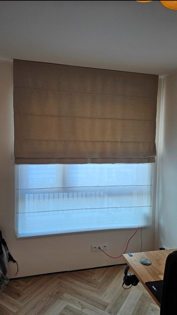 Roleta rzymska dzień-noc składa się z dwóch materiałów jeden jest firanką, a drugi zasłonka.