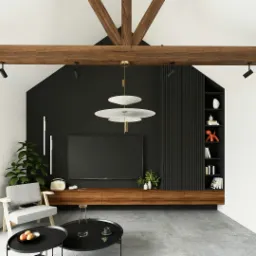 Jasne, przestronne wnętrze salonu z wysokim sufitem i drewnianymi belkami, czarną ścianą z telewizorem i drewnianą szafką RTV, szarym fotelem i stolikami kawowymi na betonowej podłodze.