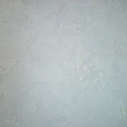 Jasnoszara ściana pokryta dekoracyjną strukturą z efektem delikatnych, nieregularnych wzorów i subtelnych cieni.