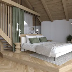 Jasna sypialnia na poddaszu z drewnianą podłogą w jodełkę, schodami z ażurową balustradą, białym łóżkiem z zielonymi poduszkami i lampami w kształcie gałązek.