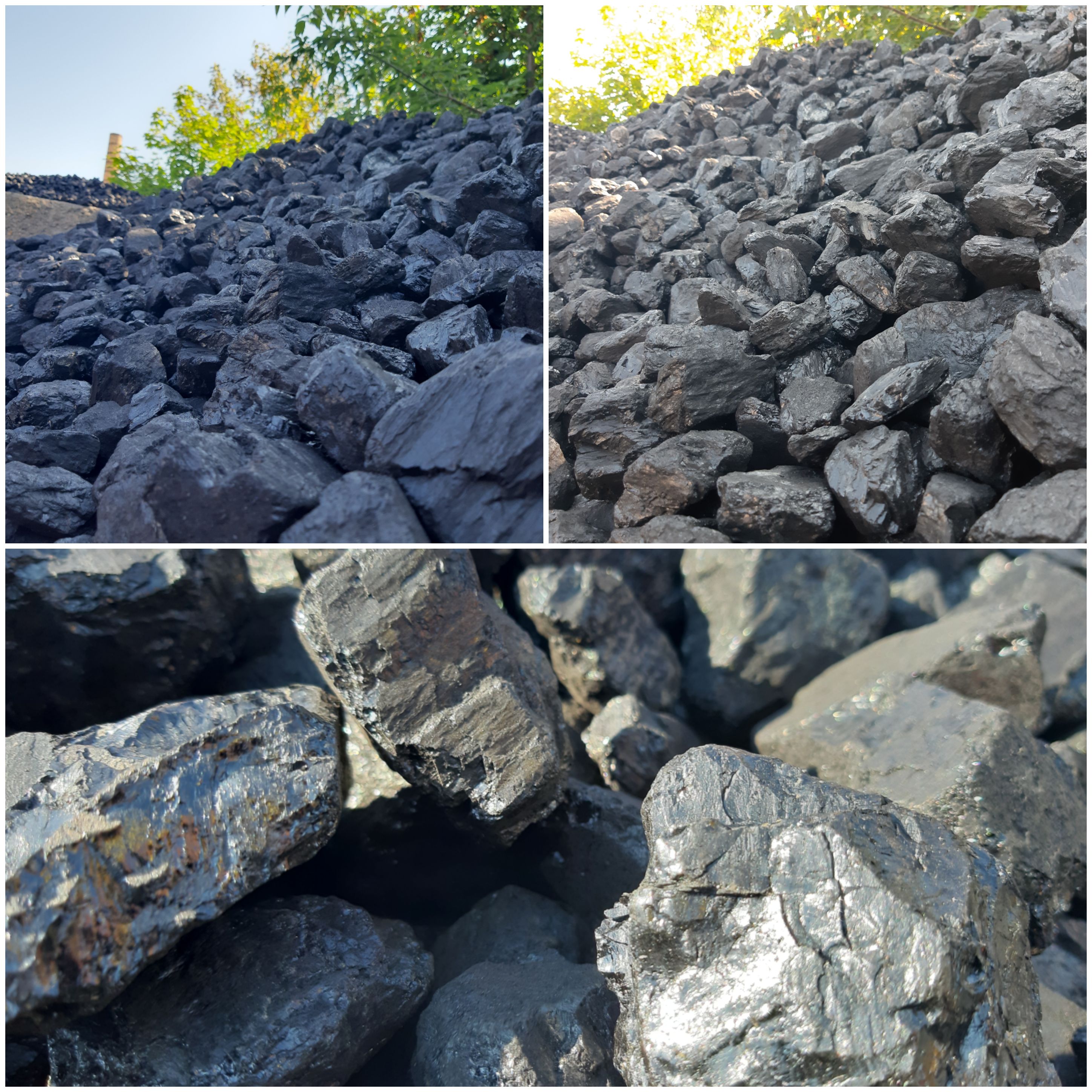 Kopalniany węgiel kamienny o nieregularnych kształtach, błyszczący w słońcu, z widocznymi fragmentami roślinności w tle i kominem w oddali.