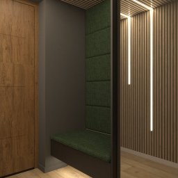 Flormeb - Wnęka z siedziskiem obitym zieloną tkaniną, z pionowymi panelami tapicerowanymi, wkomponowana w korytarz z drewnianą podłogą i lamelami ściennymi z oświetleniem LED.