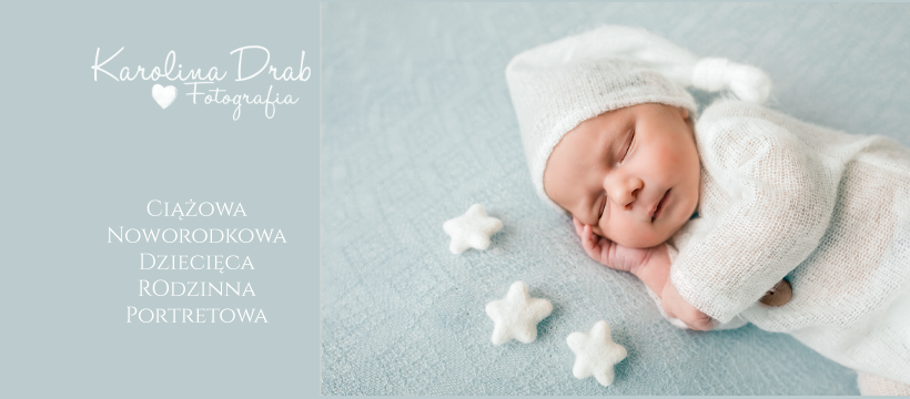 Śpiący noworodek w białym, dzierganym ubranku i czapce, leżący na błękitnym tle z trzema białymi gwiazdkami.